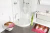 A modern bathroom with a toilet, shower, and sink, featuring decorative toilet seat and bath mats with a romantic forest path design. Náhled obrázku produktu