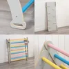 A collage of four close-up images showing different parts of a wooden climbing structure for children. Voir les images du produit