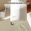 A hand holding a white electric water cup over a sink, with water pouring out of the bottom. Produktbild-Vorschau