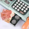 A close-up of a toy cash register with play money and coins in the drawer. Produktbild-Vorschau