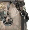 A close-up view of a handbag with a decorative charm. Podgląd zdjęcia produktu