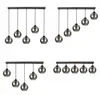 Four different configurations of a black pendant light fixture with glass globes against a white background. Náhled obrázku produktu