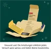 An open cardboard box with instructions and a small pouch of glittery material inside, set against a dark teal background with festive snowflakes. Anteprima dell’immagine prodotto