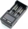 A black battery charger with two slots and a digital display. Anteprima dell’immagine prodotto