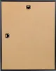 The back of a black picture frame with hanging hardware. Produktbild-Vorschau