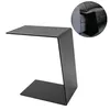 A black C-shaped side table is shown against a white background. A small inset image shows the table tucked next to a sofa. Produktbild-Vorschau
