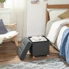 A bedroom scene with a bed, chair, and storage ottoman. Náhled obrázku produktu