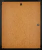 The back of a black picture frame with a brown backing board. Produktbild-Vorschau