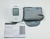 An Omron blood pressure monitor, its cuff, and instruction manual are laid out on a white background. Náhľad obrázku produktu