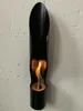 A black ethanol fireplace mounted on a white brick wall. Produktbild-Vorschau