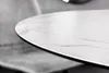 A close-up shot of the edge of a round table with a marble-like pattern. Produktbild-Vorschau