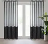 Two black and gray curtains hanging in front of a window. Produktbild-Vorschau
