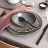 A table setting with plates, a bowl, cutlery, and a napkin. Produktbild-Vorschau