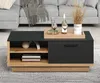 A modern coffee table with storage, placed in a living room setting with a sofa in the background. Voir les images du produit