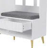 A close-up view of a white storage unit with a gray cushion on top, an open drawer with a fluted front, and gold legs. Produktbild-Vorschau