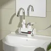 A close-up shot of a modern bathroom faucet with a digital display, mounted on a white sink. Produktbild-Vorschau
