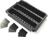 A black plastic organizer tray with three compartments, shown from a diagonal angle on a white background. Several small black square inserts are scattered in front of the tray. Produktbild-Vorschau