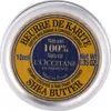 A top-down view of a small, round metal tin of L'Occitane Shea Butter. Voir les images du produit