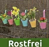 Colorful hanging flower pots with plants on a fence. Produktbild-Vorschau