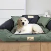 A golden retriever puppy lies on a dog bed in a room. Náhled obrázku produktu