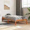 A bedroom scene with a wooden bed frame and bedding. Produktbild-Vorschau