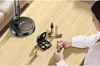 A woman applying makeup at a table with a desk lamp and various makeup products. Voir les images du produit