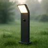 A black garden lamp with a motion sensor stands in a grassy yard with dew drops on the grass. Náhľad obrázku produktu