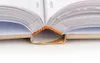 A close-up view of the spine and pages of an open book. Náhľad obrázku produktu