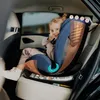 A young child is sitting in a car seat in the back seat of a car. Produktbild-Vorschau