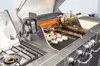 A close-up view of a stainless steel BBQ kitchen with a rotisserie chicken and stuffed mushrooms cooking on the grill. Produktbild-Vorschau
