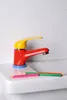 A colorful faucet on a white sink with colored pencils. Anteprima dell’immagine prodotto