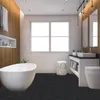 A modern bathroom with a freestanding bathtub, double vanity, and toilet, featuring wood-paneled walls and a large window. Náhled obrázku produktu