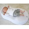 A baby sleeping on a white baby lounger. Anteprima dell’immagine prodotto
