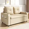 A beige sofa in a living room setting, with decorative items on a shelf in the background. Produktbild-Vorschau
