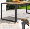 A close-up view of a wooden outdoor table with a metal frame, set on a patio with grass in the background. Podgląd zdjęcia produktu