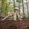 Children playing on a wooden playground in a forest setting. Náhled obrázku produktu