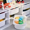 A white storage unit for children's toys with several white plastic bins, some containing colorful play-doh containers. Produktbild-Vorschau