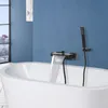 A modern bathroom with a freestanding bathtub and a black waterfall faucet filling the tub. Náhled obrázku produktu