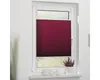 A burgundy pleated blind is installed on a white window frame, covering the lower part of the window. A small potted plant with purple flowers sits on the windowsill below. Produktbild-Vorschau
