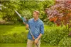 A man is holding a long-handled pruning tool in a garden setting. Produktbild-Vorschau