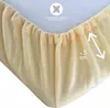 Close-up of the elasticated edge of a fitted sheet, showing the texture and gathering. Produktbild-Vorschau