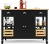 A black kitchen island with a wooden countertop, featuring drawers, cabinets, and open shelves with various items like jars, bottles, and fruit. Produktbild-Vorschau