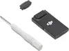 A flat lay of a DJI mobile dongle, a small black accessory, a SIM card tray ejector tool with a white handle, and a small black plastic piece, all on a white background. Produktbild-Vorschau