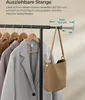 A close-up of a clothes rack with coats and a handbag, showing an adjustable rod. Produktbild-Vorschau