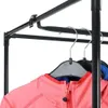 A close-up view of a pink jacket hanging on a garment rack. Náhled obrázku produktu