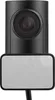 A close-up, front-facing view of a black dash cam with a white adhesive pad on the bottom. Produktbild-Vorschau