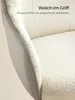 Close-up of a chair's armrest and seat, highlighting the Sherpa fabric texture and a leather-like material. Produktbild-Vorschau