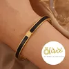 XCOAST Armreif aus Edelstahl – goldfarben mit schwarzen Produktbild-Vorschau 2