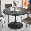 A round black marble dining table with a pedestal base, surrounded by chairs. Decorative items are on the table. Produktbild-Vorschau