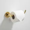 A gold toilet paper holder mounted on a white wall, with a roll of toilet paper on it. Produktbild-Vorschau